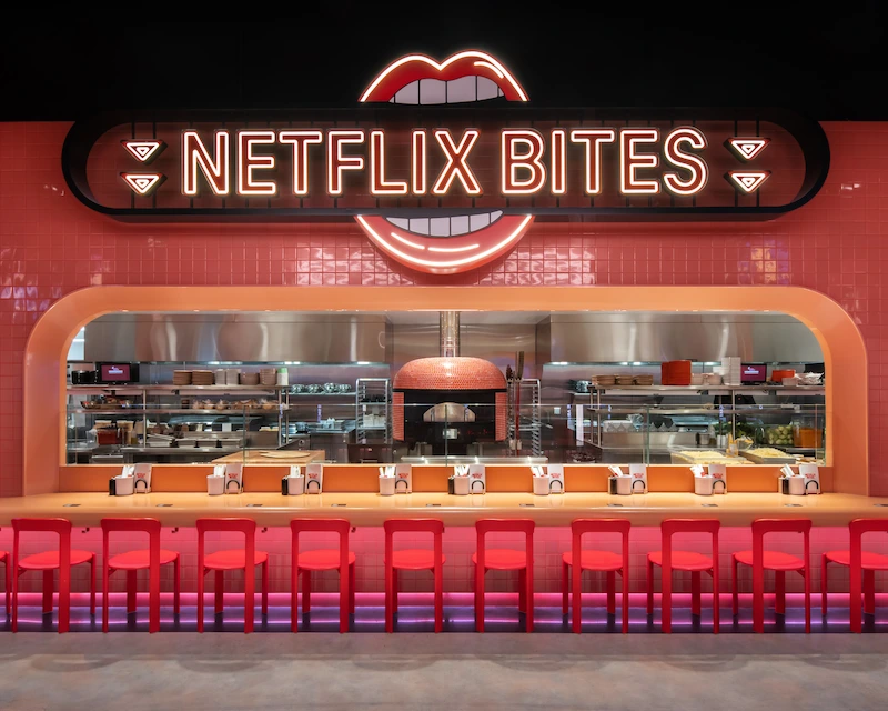 The bar and exposed kitchen of Netflix Bites is lit up.