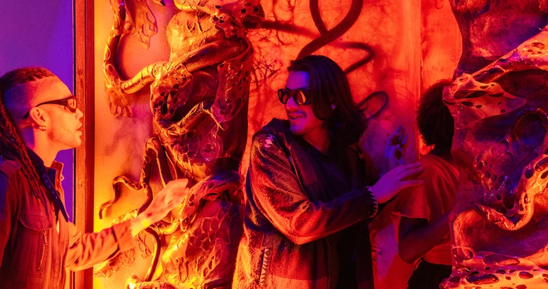 Guests touching the walls of the upside down in Stranger Things experience