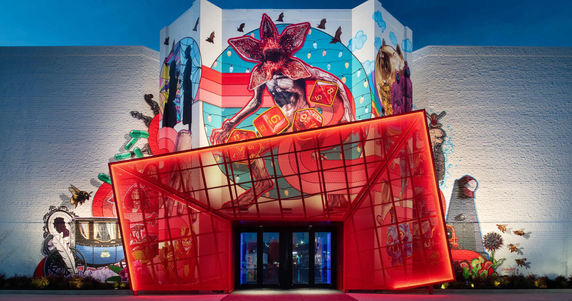 A colorful Netflix-themed mural covers the side of a building behind a red envelope-shaped entrance